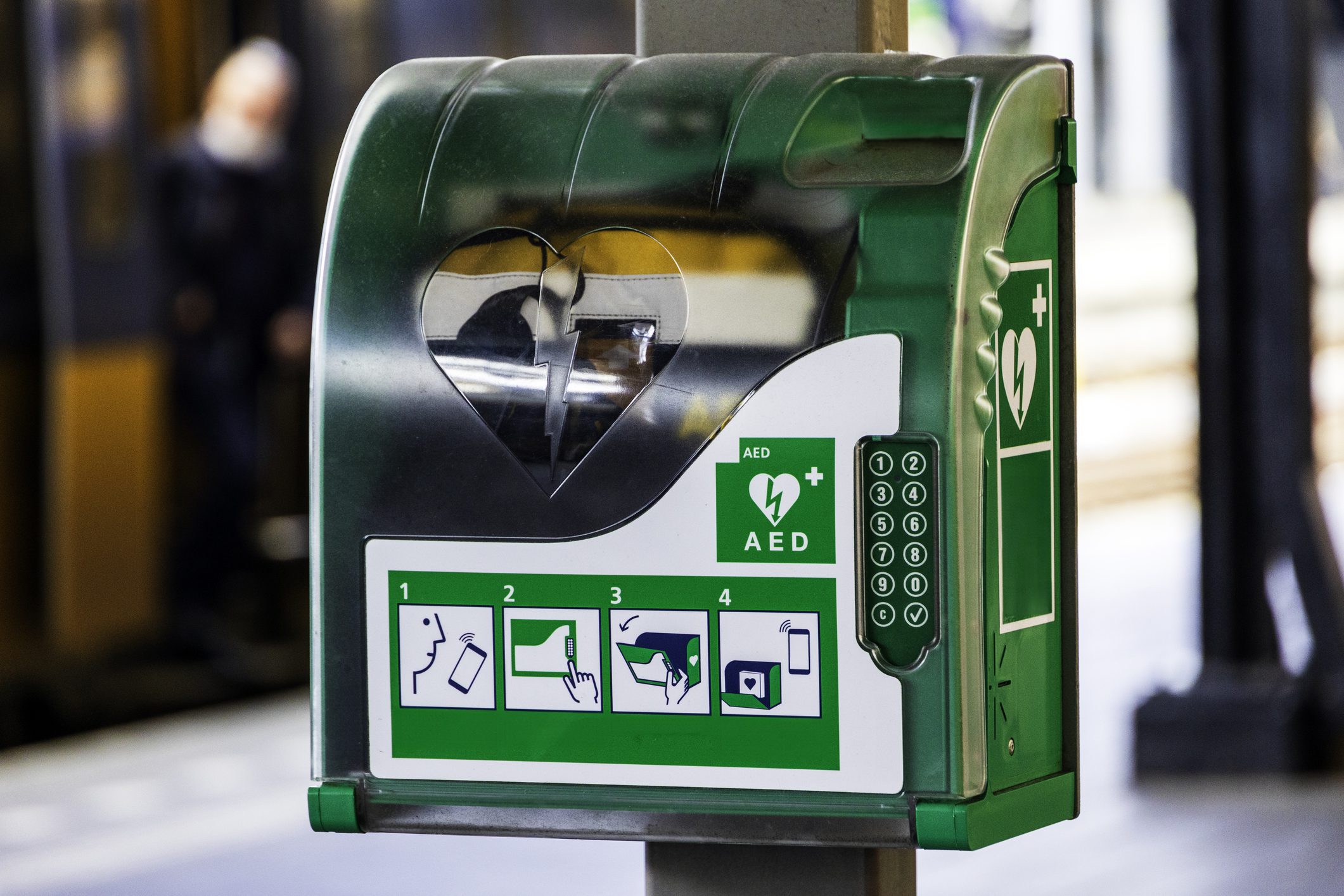 Defibrillator AED in cabinet with green and white symbol (numbers and logo's from the manufacturer have been removed)