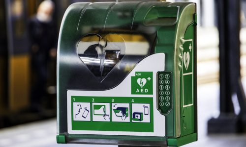Defibrillator AED in cabinet with green and white symbol (numbers and logo's from the manufacturer have been removed)