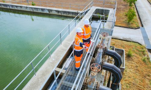 Aerial View of Two Environmental engineers work at wastewater treatment plants, Water management concept.